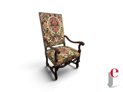 an old chair with a floral upholstered back and arms