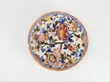 a plate with flowers on it on a white surface