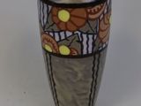 a vase that is sitting on a white surface