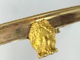 a close up of a gold ring on a twig