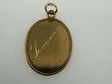 a close up of a gold locke with a name engraved on it