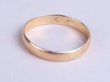 a close up of a gold ring on a white surface