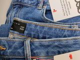 three pairs of blue jeans are stacked on top of each other