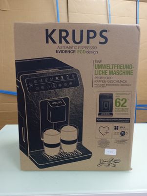 packaging of a coffee machine sitting on a table in front of a cardboard box