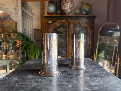 two salt and pepper shakers sitting on a table