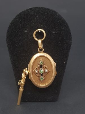 a close up of a gold locke with a key on a black stand