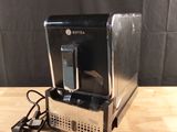 a coffee maker that is sitting on a wooden table
