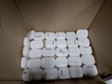 a cardboard box with a bunch of white electronic devices in it
