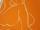 an image of a drawing of a woman sitting on an orange surface