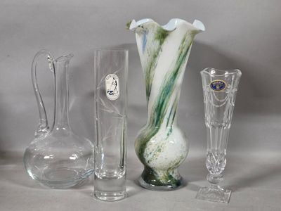 several glass vases and vases are sitting on a table