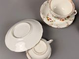 three cups and saucers sitting on a table next to each other