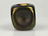 a close up of a black and gold ring on a white surface