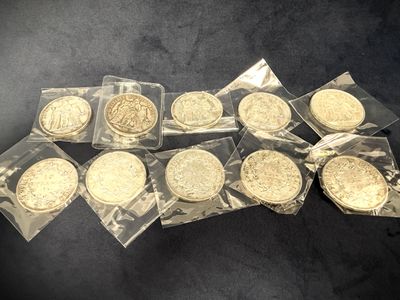 a pile of gold coins sitting on top of a black table