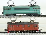 two trains that are sitting on the tracks together