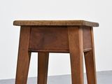 a small wooden table with a drawer on it