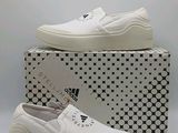 a pair of white shoes sitting on top of a box