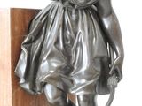 a bronze statue of a woman holding a bow and arrow