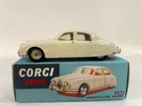a white toy car sitting on top of a box