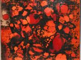 an image of a red and black painting on a white surface