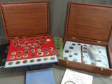 three boxes of coins and a book on a table