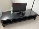 a black coffee table with a television on it