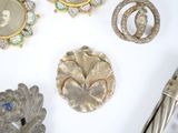 many different types of brooches on the table