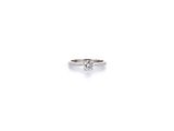 an image of a diamond ring sitting on top of a white surface