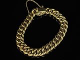 a gold bracelet on a black background
