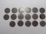 a bunch of coins sitting on top of a white surface