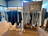 a lot of clothes hanging on a rack in a store