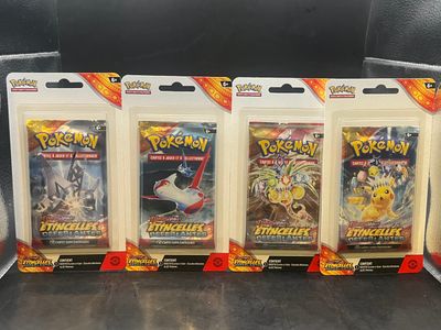 four packs of pokemon trading cards sitting on top of a table