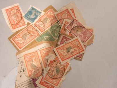 a pile of old postage stamps on a table