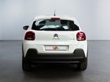 the rear of a white citrole parked in a room