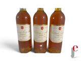 three bottles of wine sitting next to each other on a white surface