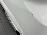 a close up of a car ' s hood with a hole in it
