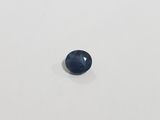 a blue sapphire stone on a white surface
