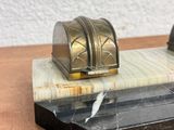 marble and brass bookends on a marble base on a wooden table