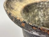 a close up of a metal bowl with rust on it