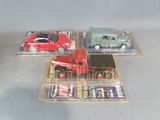 three toy cars in a plastic case on a table