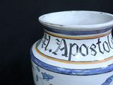 a white vase with a blue and yellow design on it