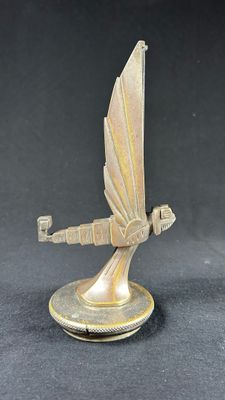 an image of a bronze statue of a flying bird on a black background