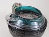 a glass jar with a ring on it sitting on a table