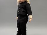 a small doll that is standing on a white plate