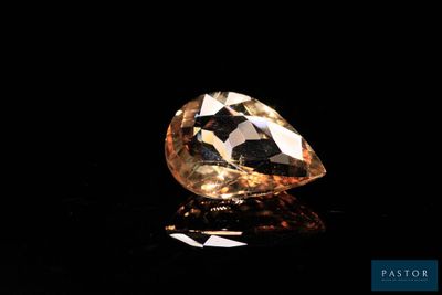 a close up of a diamond on a black surface