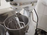 a mixer and a bowl on the counter in the kitchen