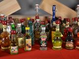 many bottles of alcohol lined up on a red table