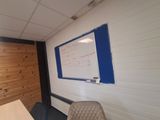 a white board on the wall in a room