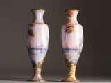 two vases that are sitting on a table