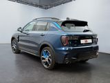the rear end of a blue bmw suv parked in a showroom