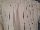the back of a white shirt with pleas on a mannequin mannequin mannequin mannequin mannequin mannequin mannequin